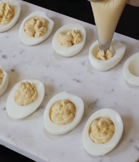 Step 1.1: Spoon the yolk mixture back into the egg whites
