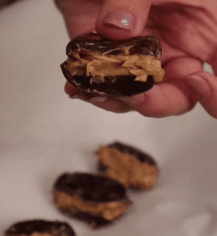 Step 1.1: Stuff each date with crunchy peanut butter and place them on a tray
