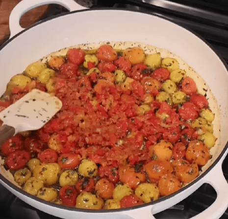 Step 4.1: Add the seared chicken and sautéed peppers and onions to the baking dish with the roasted tomatoes