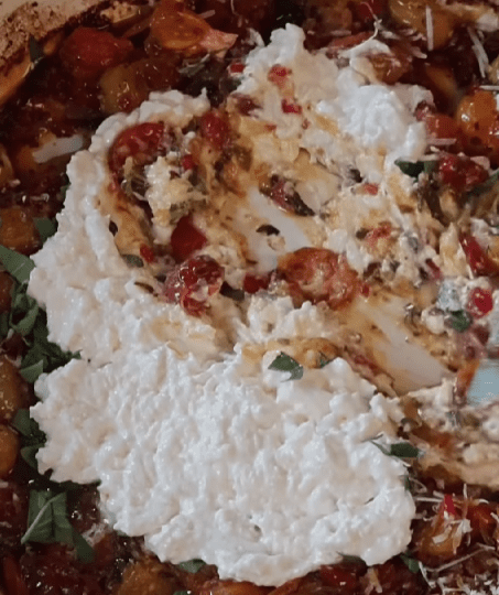 Step 5.1: Stir the stracciatella cheese into the roasted tomato mixture until creamy