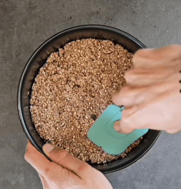 Step 1.1: Line a small cake tin with a removable base with parchment paper and press the dough into the base
