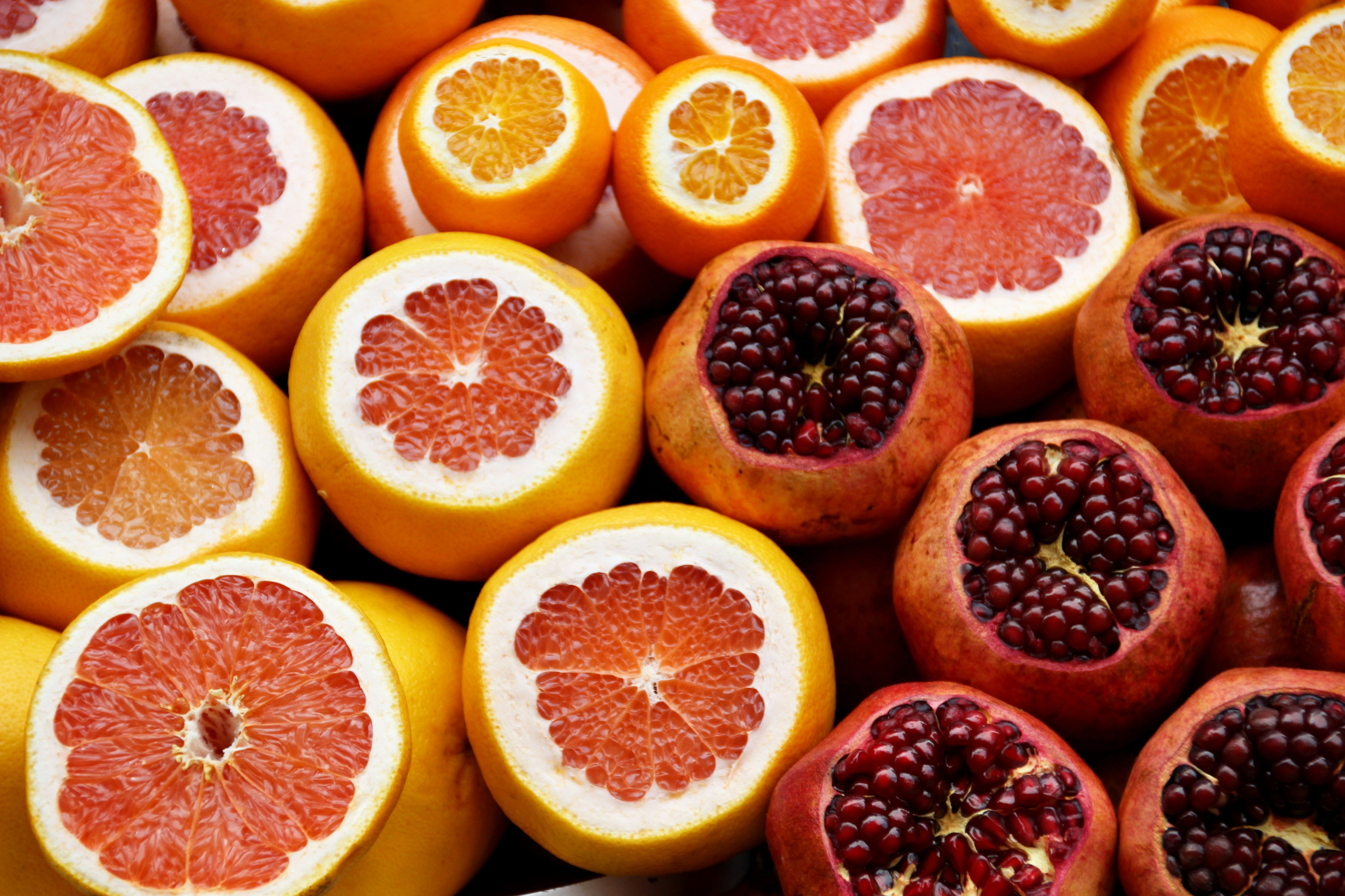 A bunch of lemons, oranges, grapefruits, pomegranates.