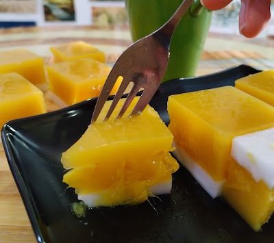 Step 1.1: Once the surface of the mango layer has set, gently pour the coconut layer over the spatula or the back of a spoon onto the mango base
