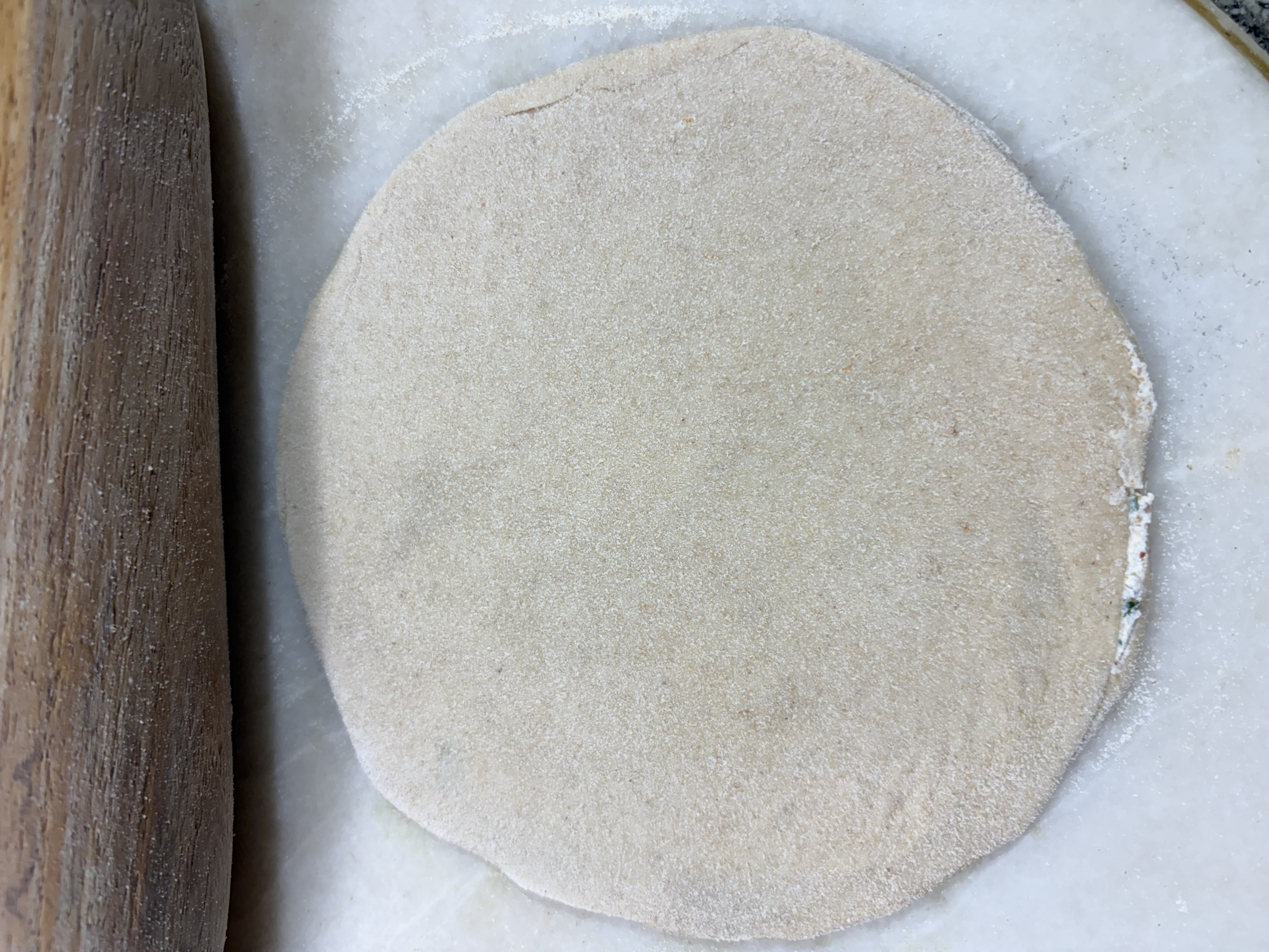 Step 4.1: Dust lightly and carefully roll it out into a slightly thick paratha