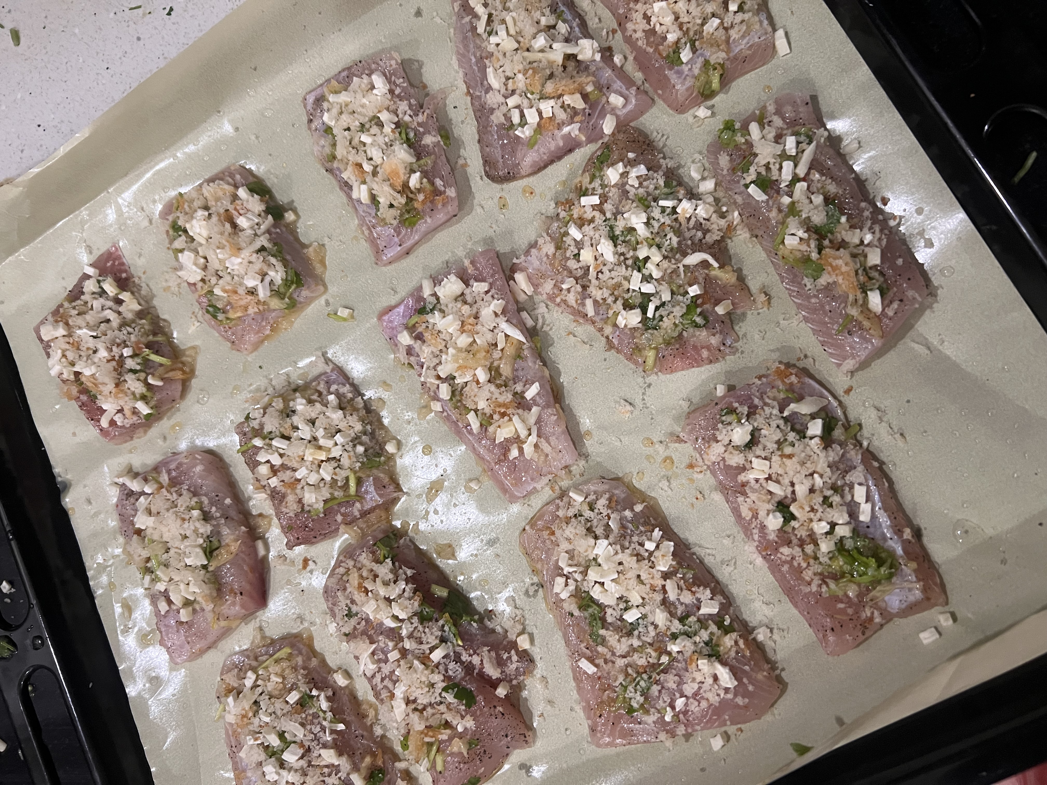 Step 1.2: Spread the breadcrumb mixture evenly on top of the fish