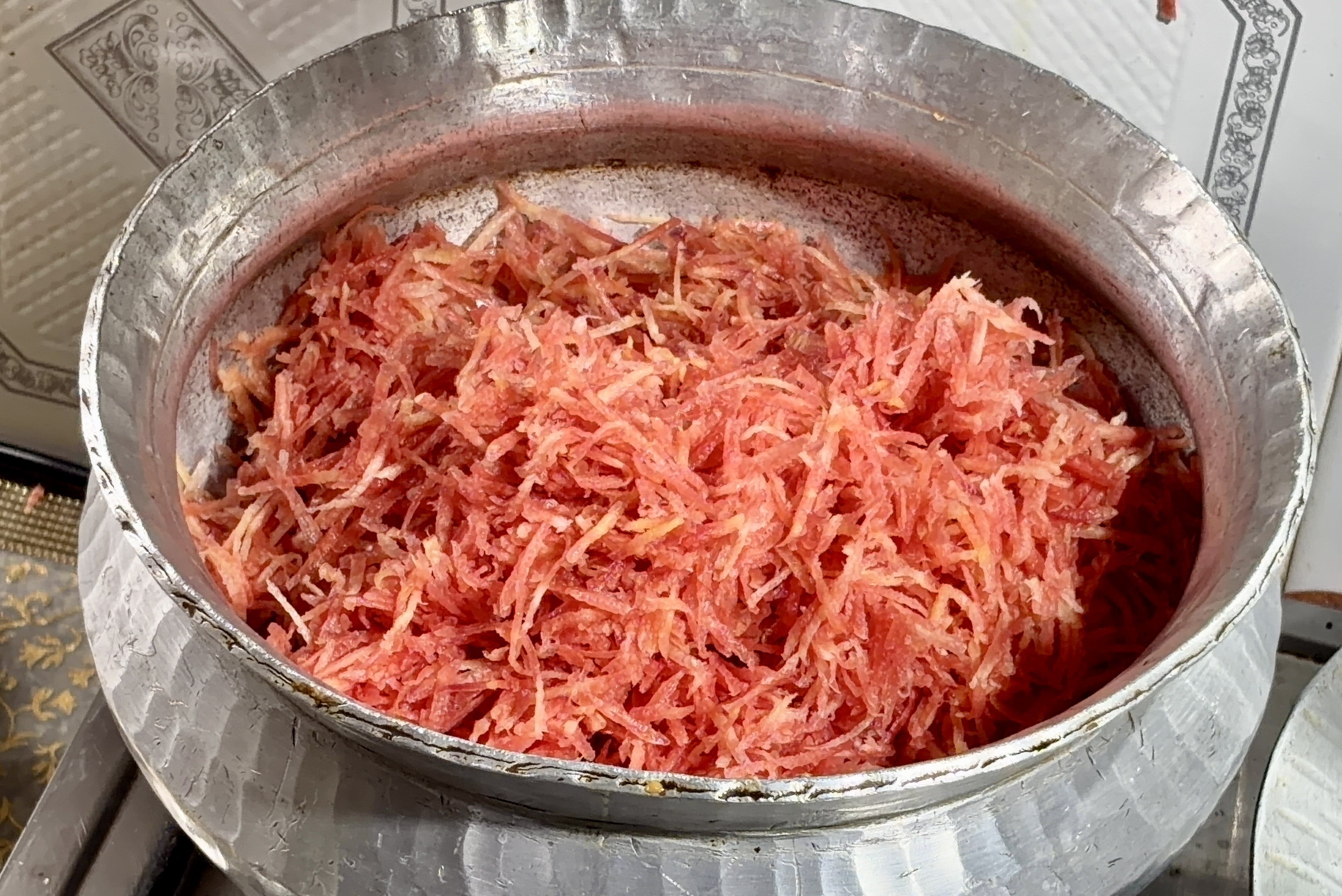 Step 1.1: In the same pan, add the grated carrots