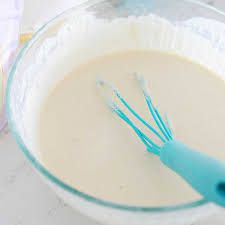Step 2.2: Gradually add warm water to the dry ingredients while stirring until you achieve a smooth, pourable batter similar to pancake batter