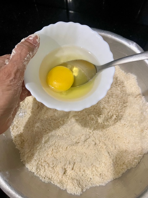 Step 1.1: Beat the egg with ice-cold water and add to the flour mixture