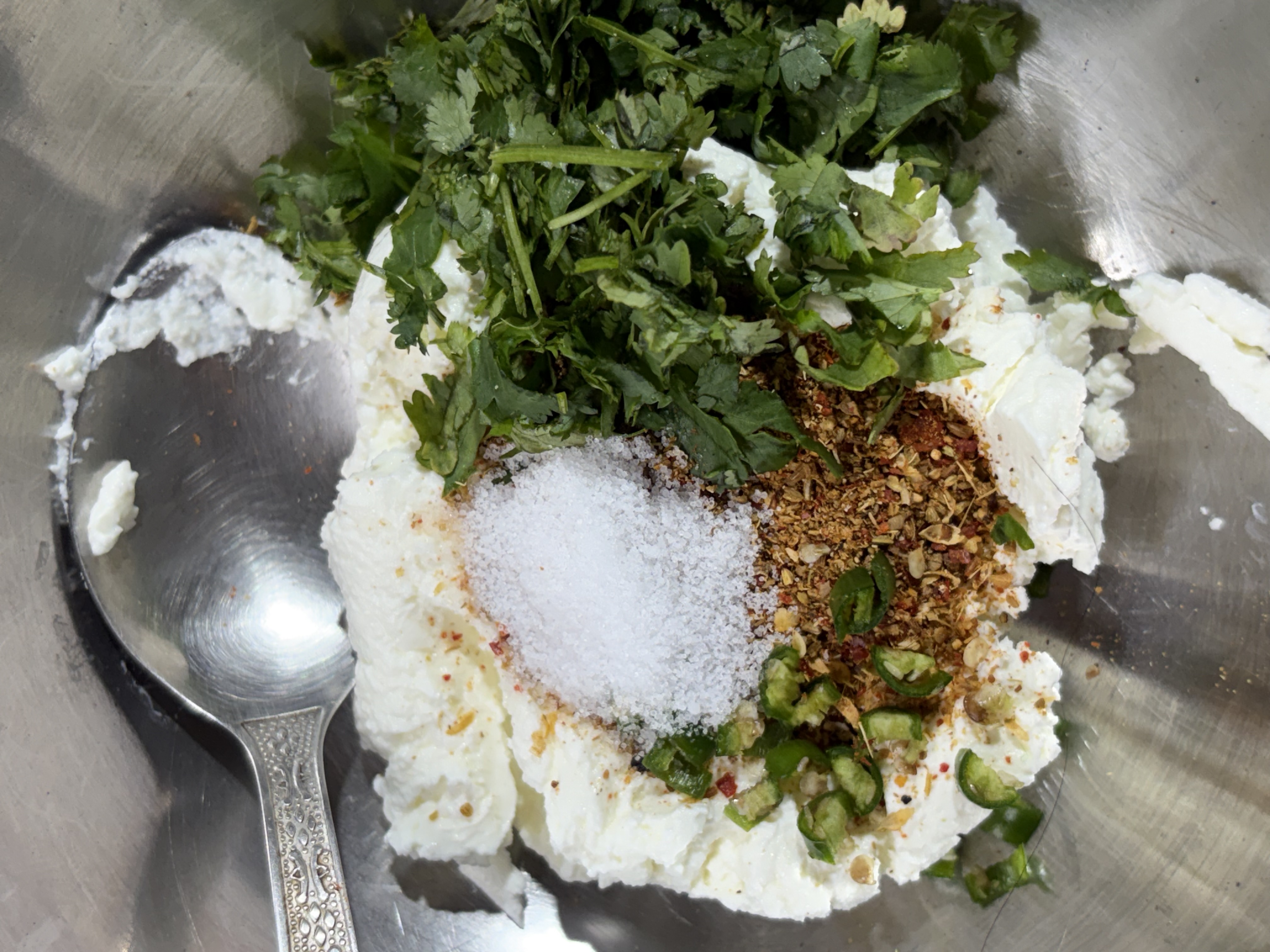 Step 3.1: Add 1 tablespoon of the prepared spice mix, chopped coriander, green chilli (if using), and salt