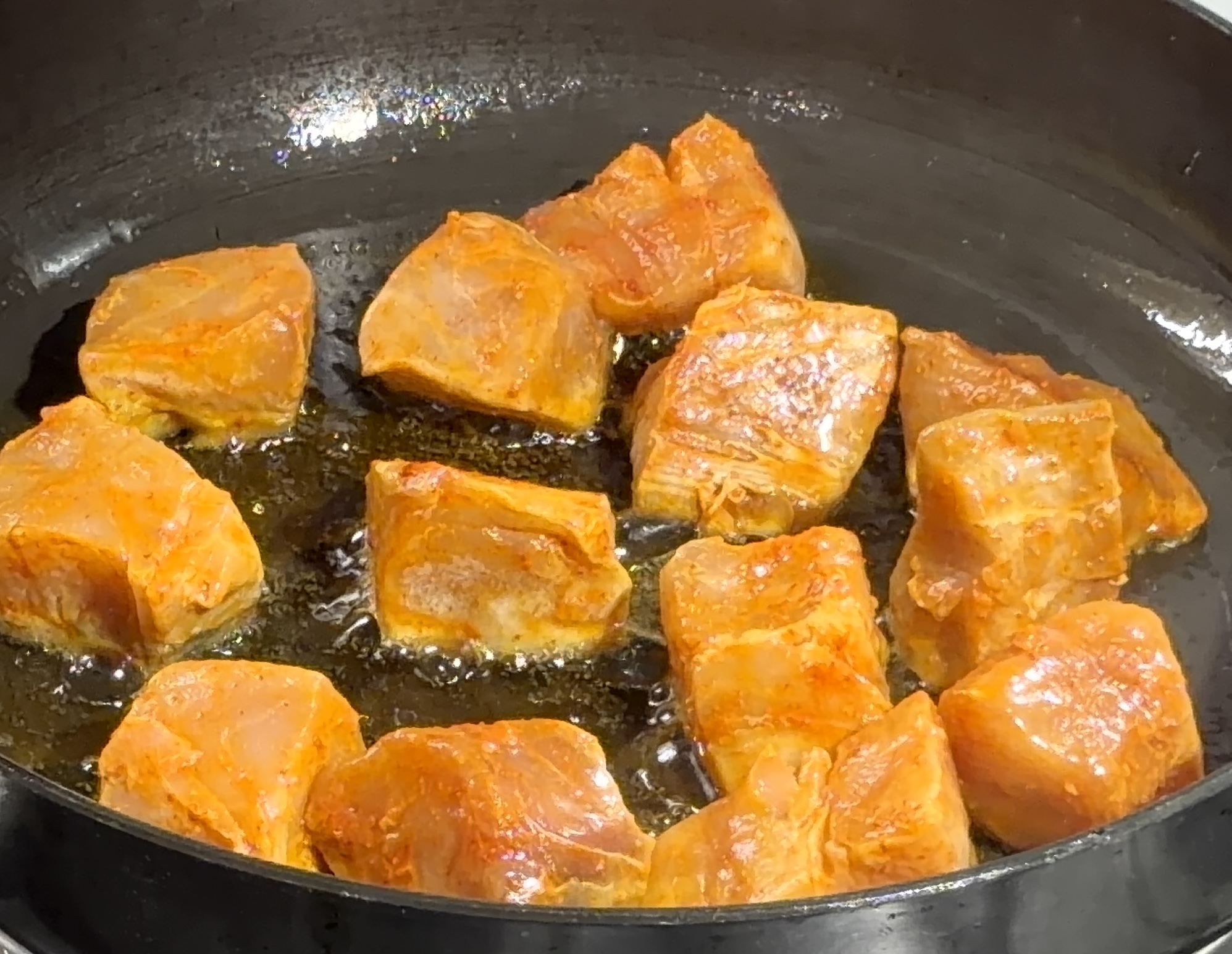 Step 2.1: Heat oil in a pan and shallow-fry the marinated fish in batches until lightly golden on both sides