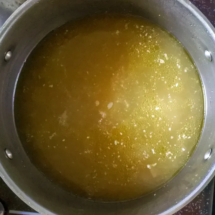 Step 3.1: In a separate pot, bring chicken broth (or water) to a boil