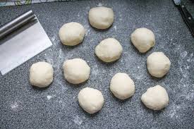 Step 5.1: Once risen, punch down the dough and divide it into small balls (about the size of a golf ball)