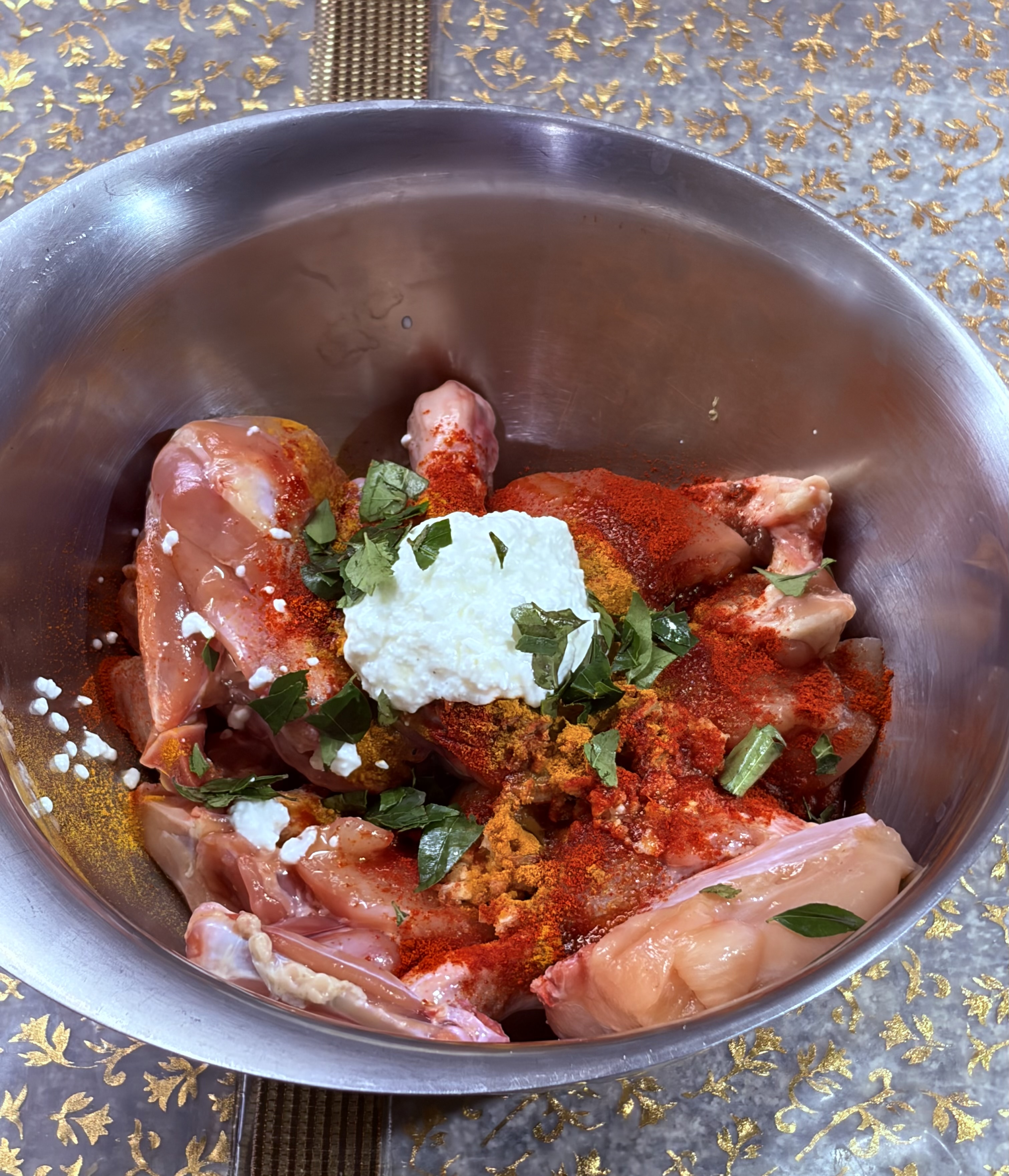 Step 1.1: In a large bowl, combine the chicken with garlic, ginger, salt, Kashmiri chilli powder, turmeric, oil, curd, and chopped curry leaves