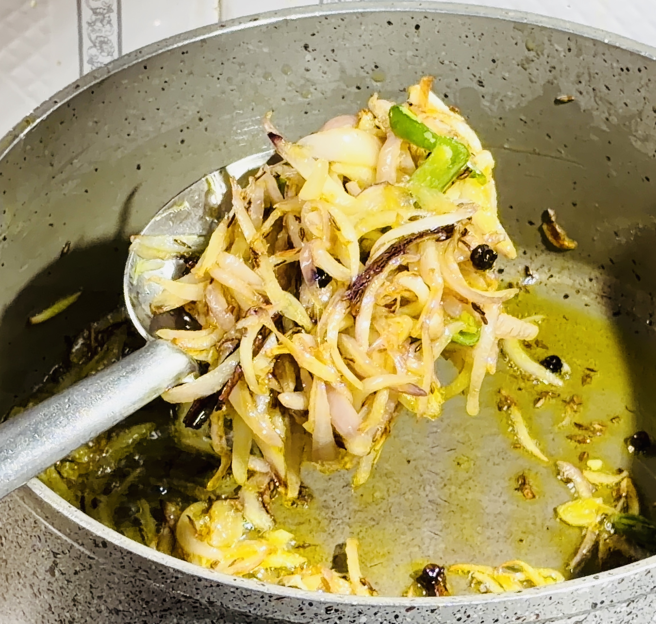 Step 3.1: Add sliced onions and green chillies