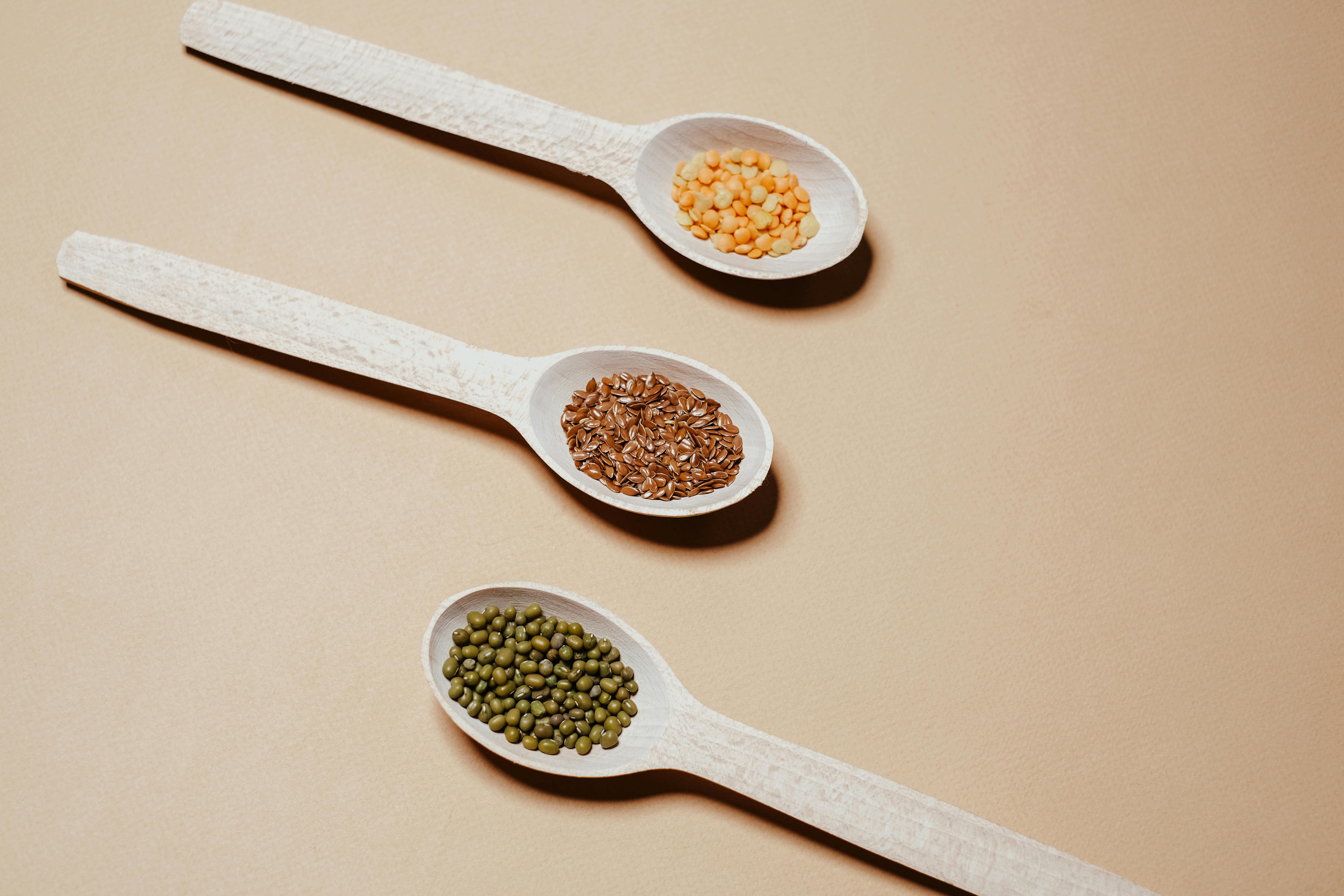 three spoons laid on the surface with different type of fiber sources
