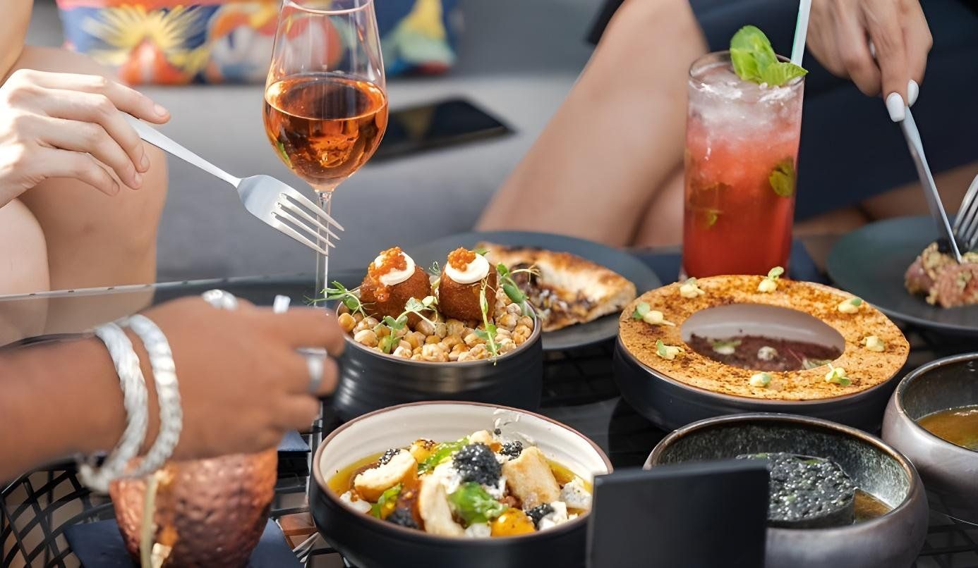 3 friends sitting and sharing different kinds of food