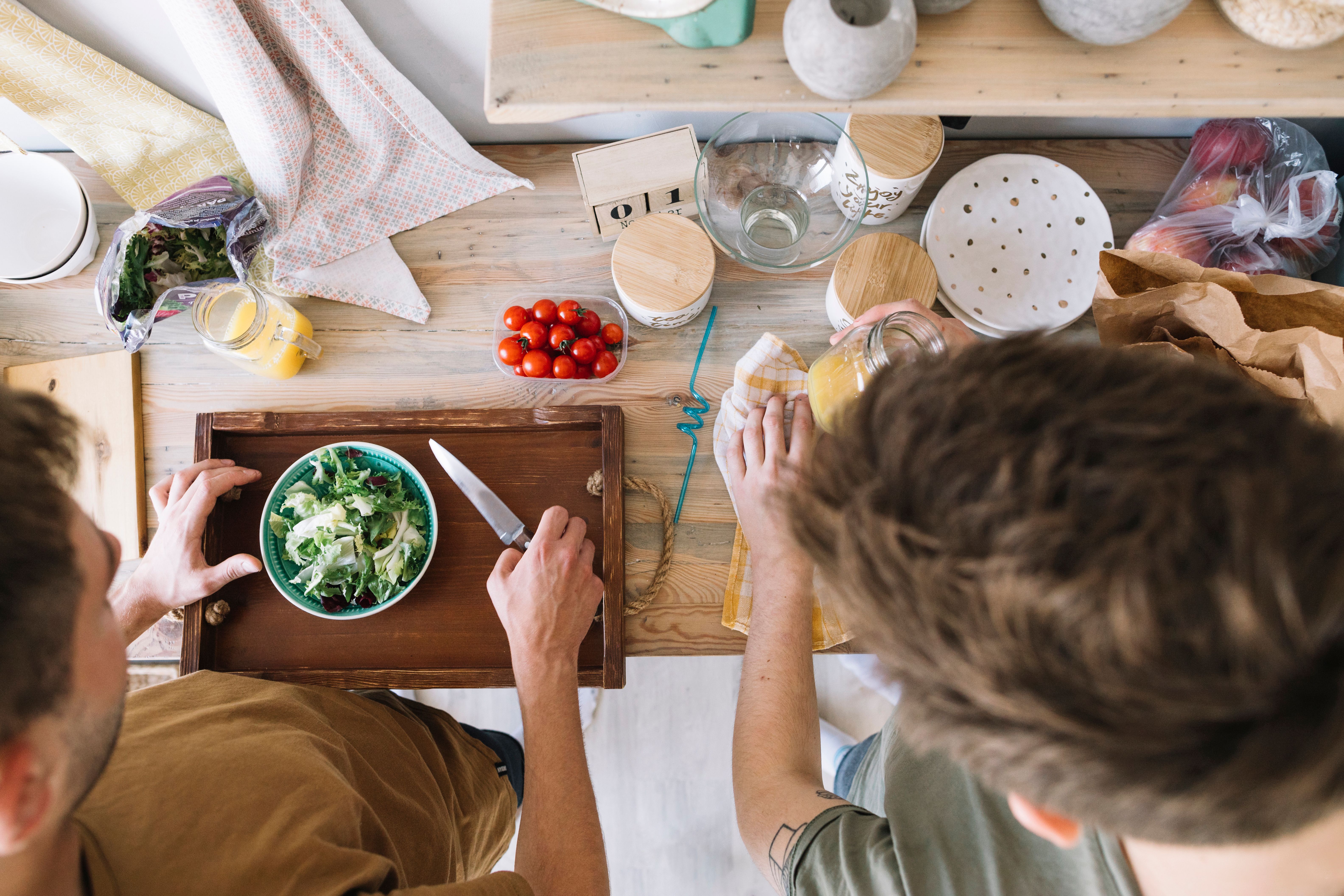 high-angle-view-friends-making-breakfast-kitchen-counter.