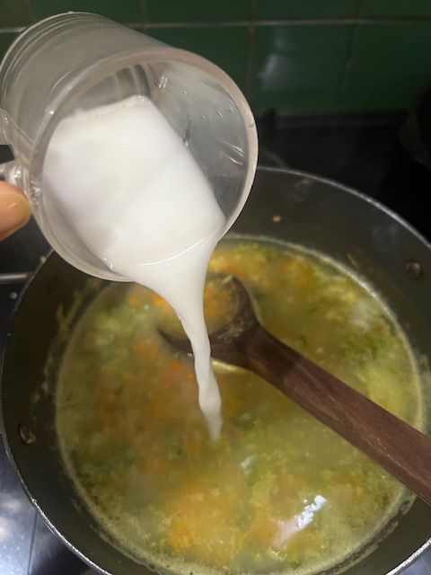 Step 5.1: Gradually add the slurry to the simmering soup, stirring constantly