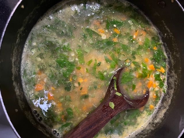Step 5.2: Gradually add the slurry to the simmering soup, stirring constantly