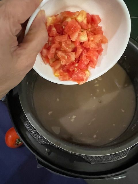 Step 2.2: Add the chopped tomato and mustard oil and stir well
