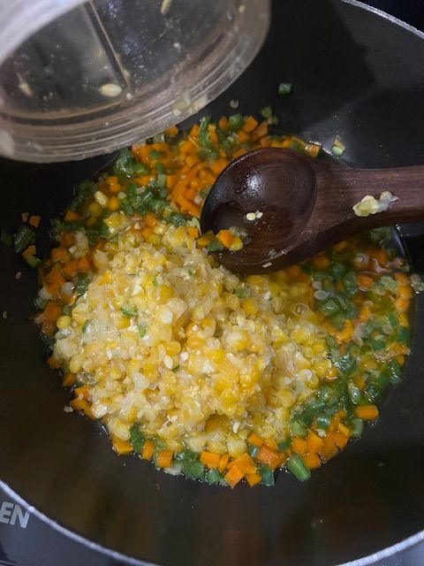 Step 4.2: Add boiled corn kernels (whole + puree if using), reserved corn water, and veggie stock