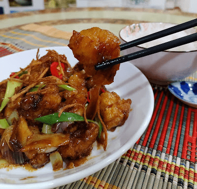 Step 1.1: Sprinkle the green part of the spring onions and sliced chilies over the dish for freshness before serving