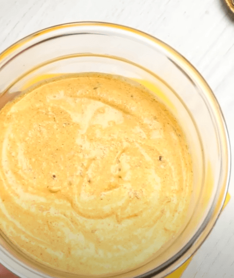 Step 2.1: In a bowl, add yogurt, cream, red chilli powder, coriander seeds, turmeric powder, red chilli, pink salt, lemon juice, and whisk well
