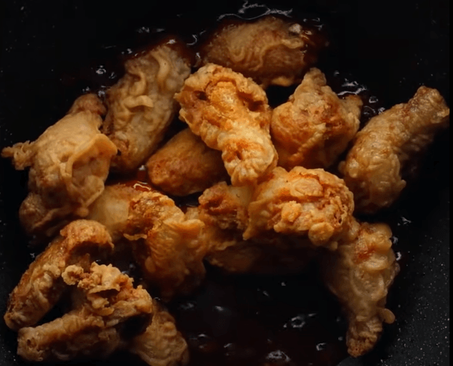 Step 4.1: Toss the fried chicken in the sauce