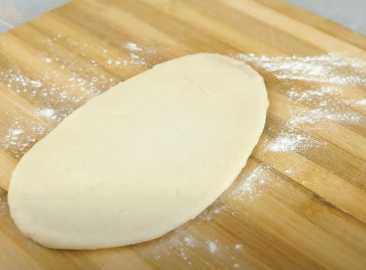 Step 2.1: Stuff with cheddar cheese, pinch, and seal the dough