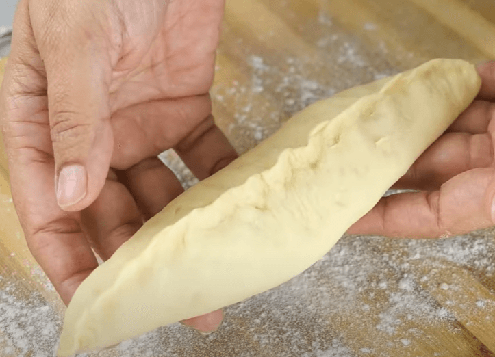 Step 2.3: Stuff with cheddar cheese, pinch, and seal the dough