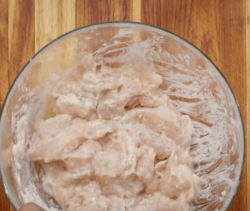 Step 1.1: In a mixing bowl, add the chicken strips, salt, garlic paste, ginger paste, white pepper, egg white, cornflour, all-purpose flour, baking soda, and a bit of water