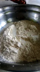 Step 1.1: Gradually pour in the hot water and oil while stirring