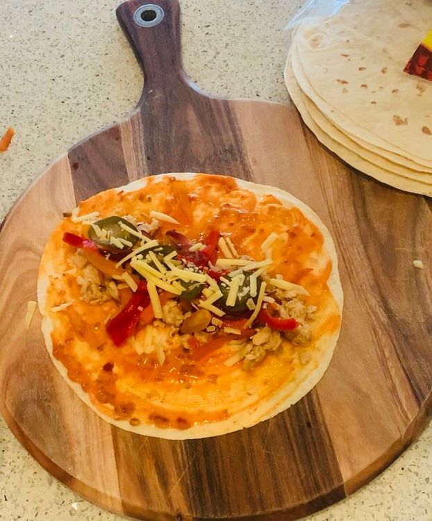 Step 1.2: Place some cooked chicken mince, capsicum, and carrots in the centre of the tortilla