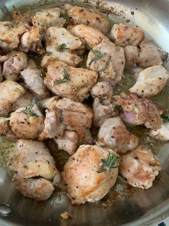 Step 3.1: Add the marinated chicken cubes to the skillet, spacing them out evenly