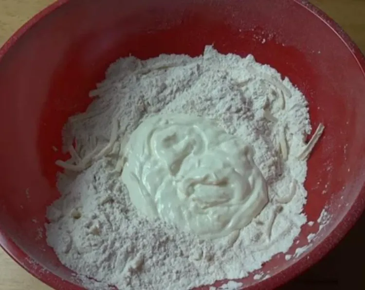 Step 1.1: In a mixing bowl, combine the self-rising flour, 1/2 cup of cheese, and a pinch of salt