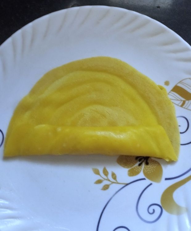 Step 4.1: Roll the crepe once, then fold the ends inward and continue rolling