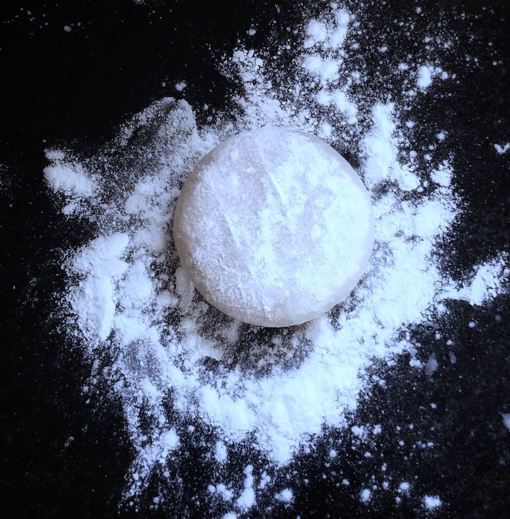 Step 1.1: Dust rice flour and roll the dough with a rolling pin into thin sheets, dusting with rice flour as needed