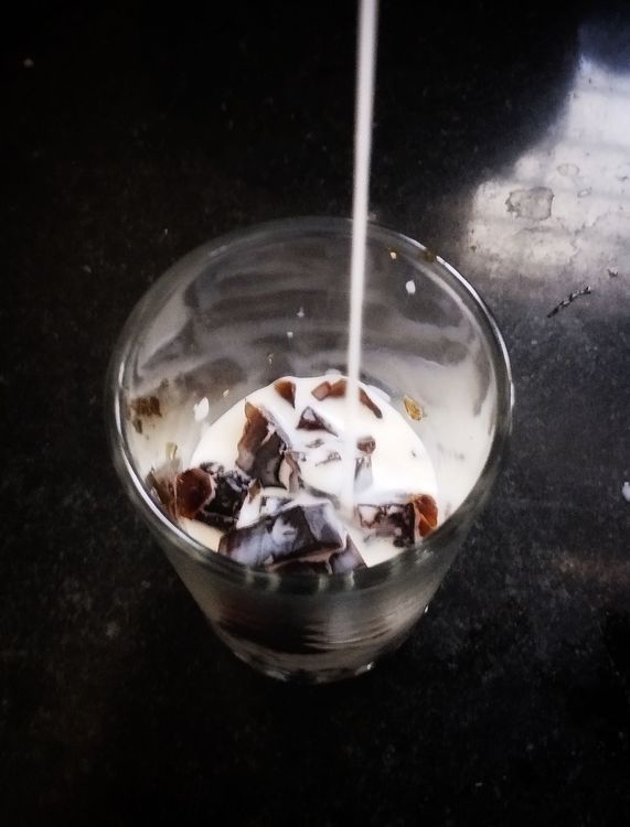 Step 1.1: In a serving glass, add coffee jelly, chilled milk, fresh cream, and condensed milk