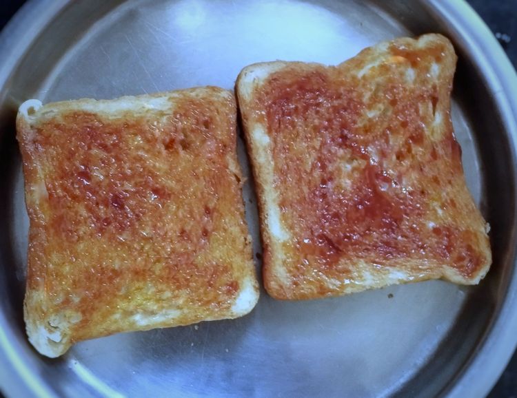 Step 2.1: Take one slice of bread, spread tomato ketchup, then spread potato masala on one bread slice