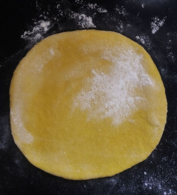 Step 2.1: Dust some flour on the rolling board and flatten the dough using a rolling pin to make a thin sheet