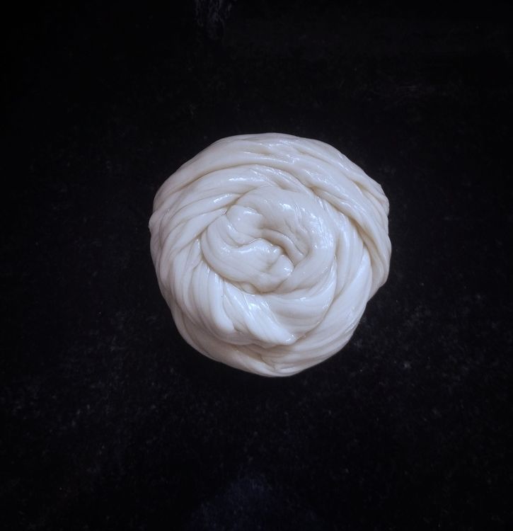 Step 2.4: Take the strips with your hand, pull slightly, and roll into a spiral