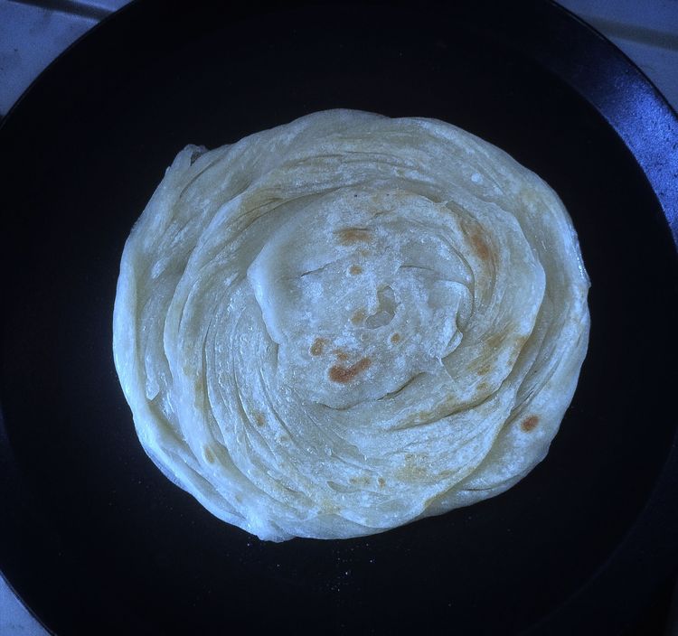 Step 3.1: Once the color slightly changes on top, spread some ghee mix and flip it