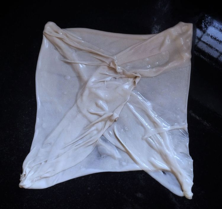 Step 2.1: First Fold all four corners to the middle, then place 1 or 2 tbsp of egg filling, and fold the corners to cover the filling