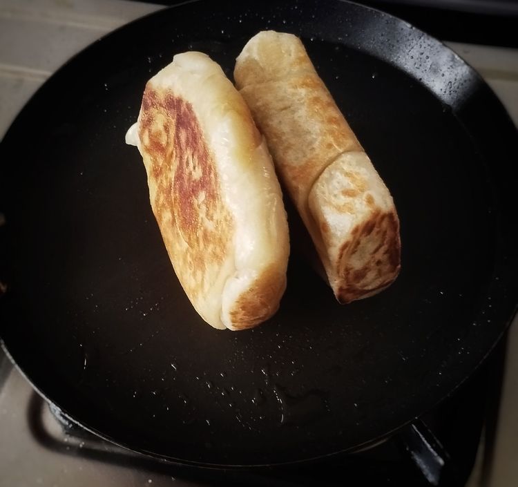 Step 2.3: Heat a pan, spread some oil, and place the parotta puffs