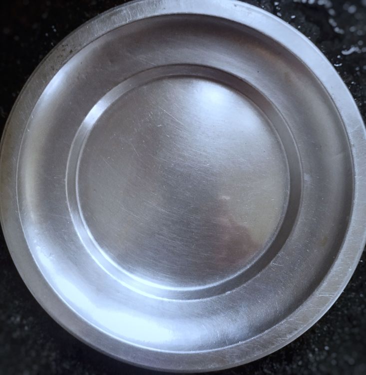 Step 1.1: Take a round plate and grease it with some oil