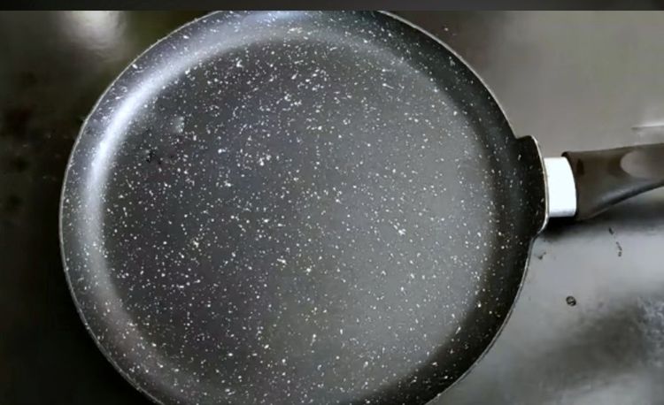 Step 1.1: Take a 10-inch flat-bottom tawa or dosa tawa, grease it with oil, and place butter paper over it