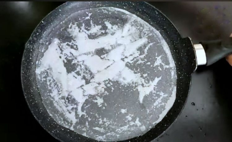 Step 1.2: Take a 10-inch flat-bottom tawa or dosa tawa, grease it with oil, and place butter paper over it