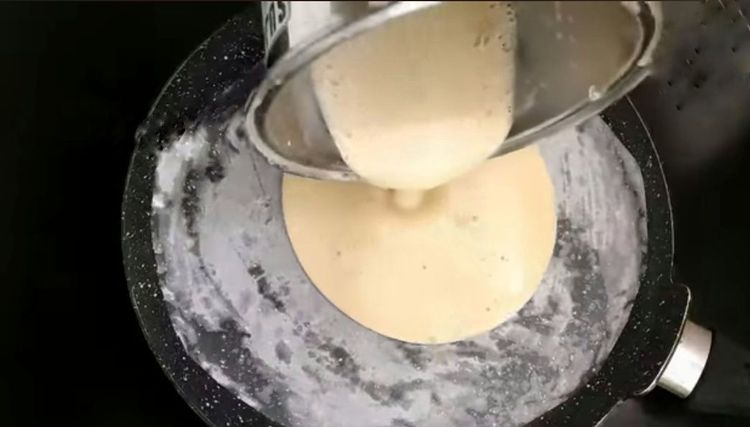 Step 1.1: Pour the cake mix onto the greased tawa