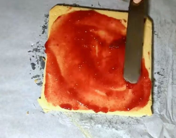 Step 1.2: Beat the jam well and spread an even layer over the cake