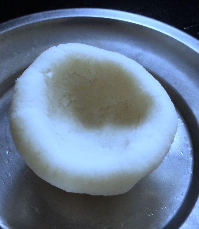 Step 2.3: Take one ball and press into the center with your thumb to make a bowl shape